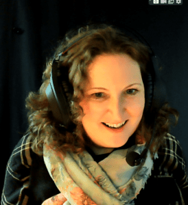 Corinne - podcast host of the " Experts Speak English Podcast" with her editing headphones on