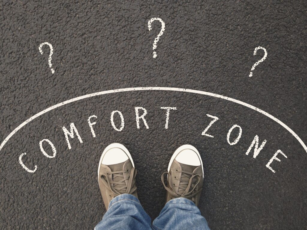 feet standing in comfort zone on street. the uncertain outside is marked with question marks.