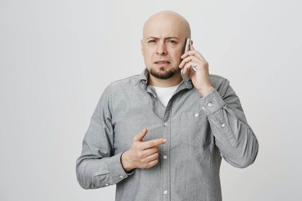 Portrait of confused man on the phone