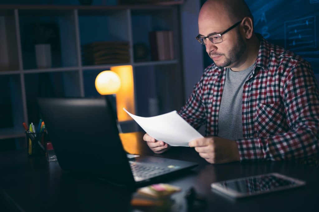 Man working late so that he can find the sources to reference in his speech